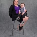 an image of a woman sitting on a stool with her 6 month old baby boy