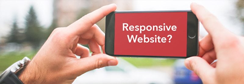 a POV image of two hands holding a cell phone in landscape mode with the words "Responsive Website?" on it.