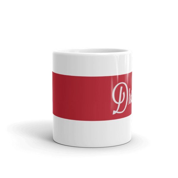 white coffee mug with red stripe and the word dream