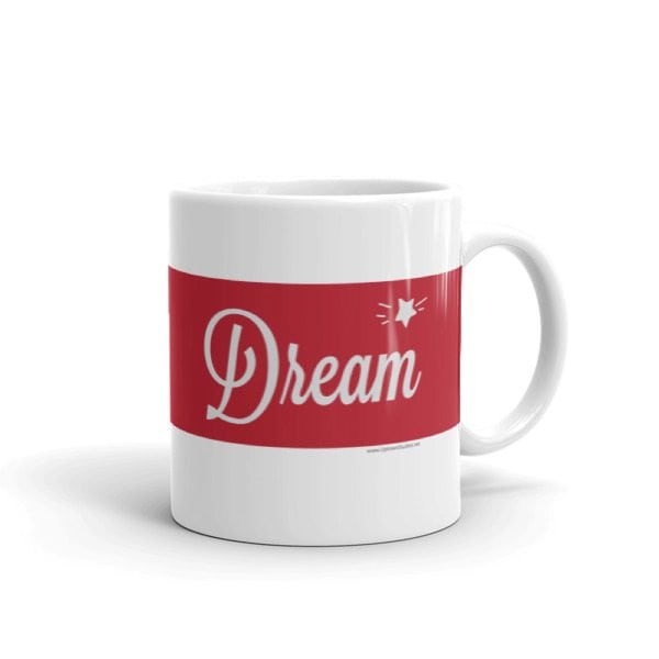 white coffee mug with e red stripe and the word dream