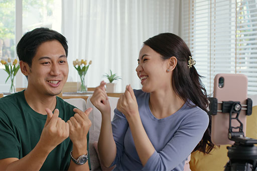 A woman and a man sitting together on a couch